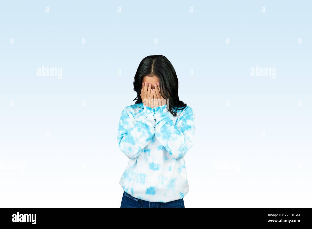 Yougn Asian girl with blue dress points and gives various expression ...