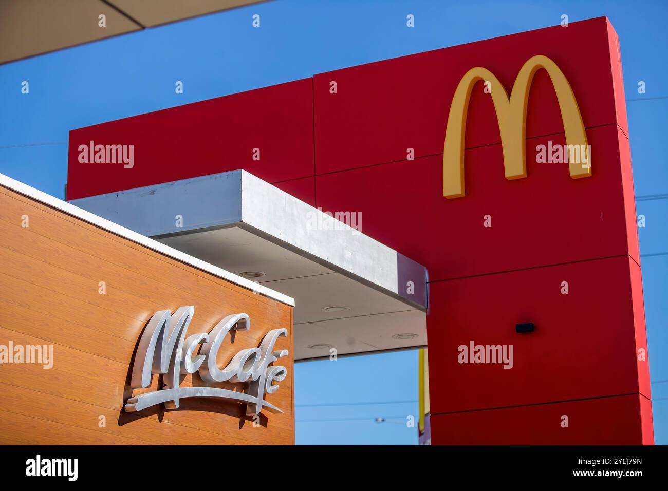 McDonald's signage with the golden arches and a McCafé logo, showcasing ...