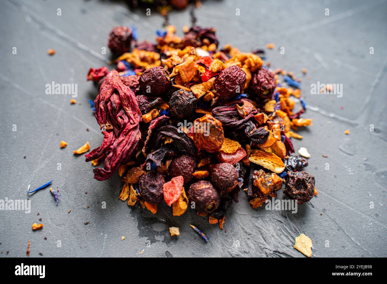Dry red hibiscus tea with various additives ha gray background. High quality photo Stock Photo