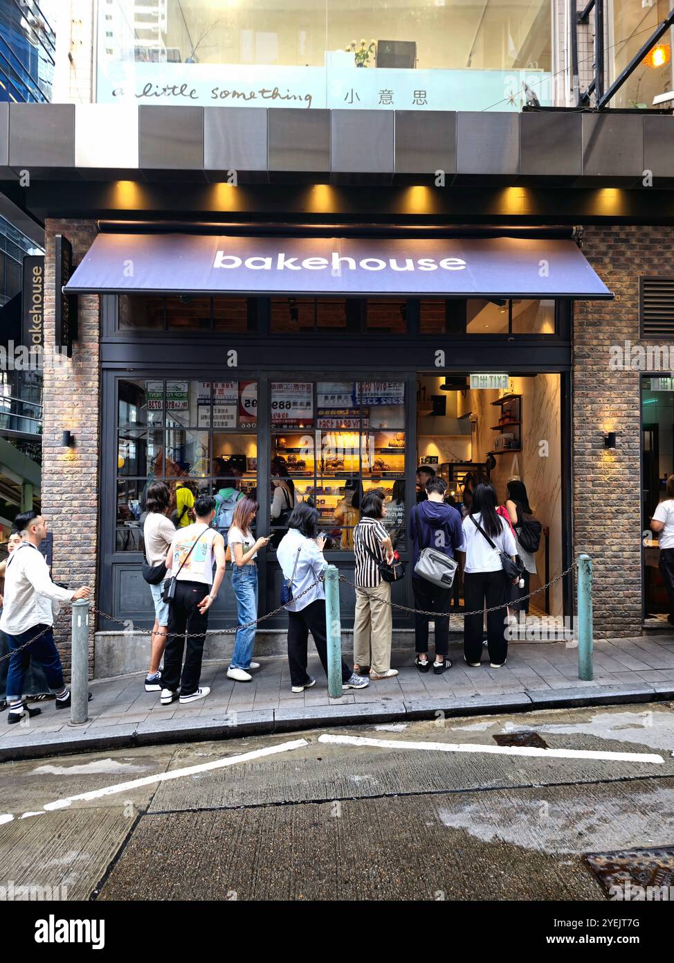 Crowed standing in line at the popular Bakehouse on Staunton street in Soho, Hong Kong. - Smartphone Captured Stock Image