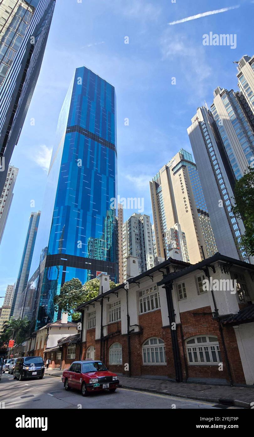 The Oil street art space center on Electric Road with the AIA tower behind it. North Point, Hong Kong. - Smartphone Captured Stock Image