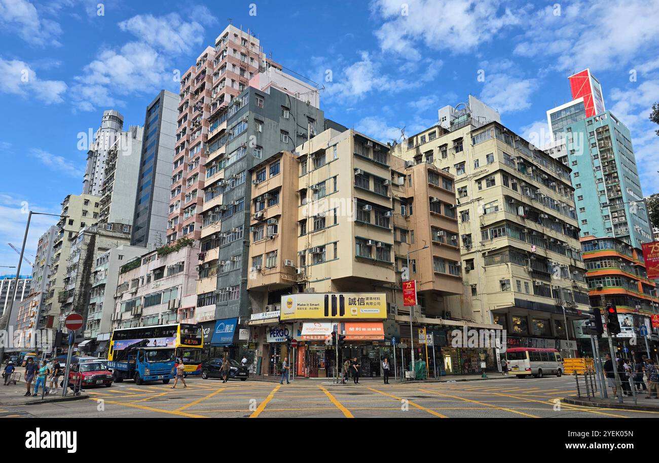 Old residential building along newer buildings at the corner of Mong Kok Rd. and Shanghai street in Kowloon, Hong Kong. - Smartphone Captured Stock Image