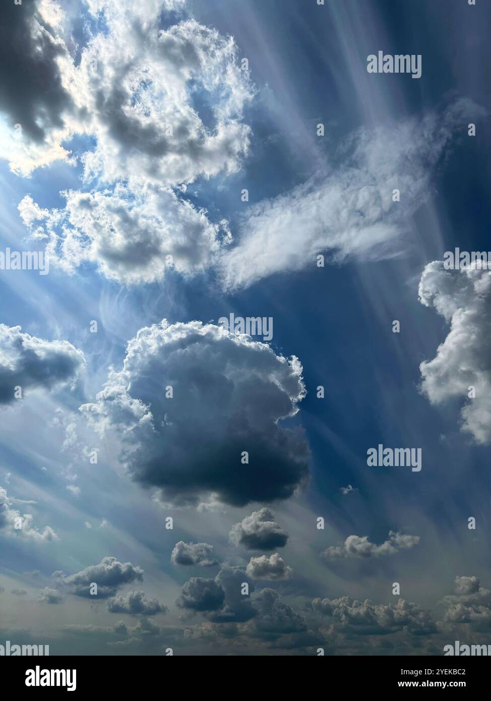blue sky with white clouds, sky scenery, the sun is shining behind the clouds - Smartphone Captured Stock Image