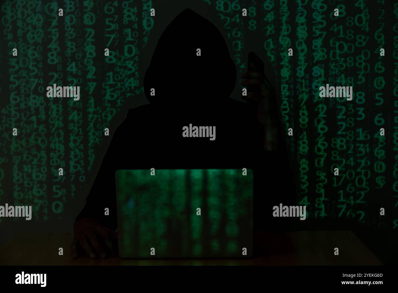 Hacker over a screen with binary code. concept of a hacker attack Stock Photo