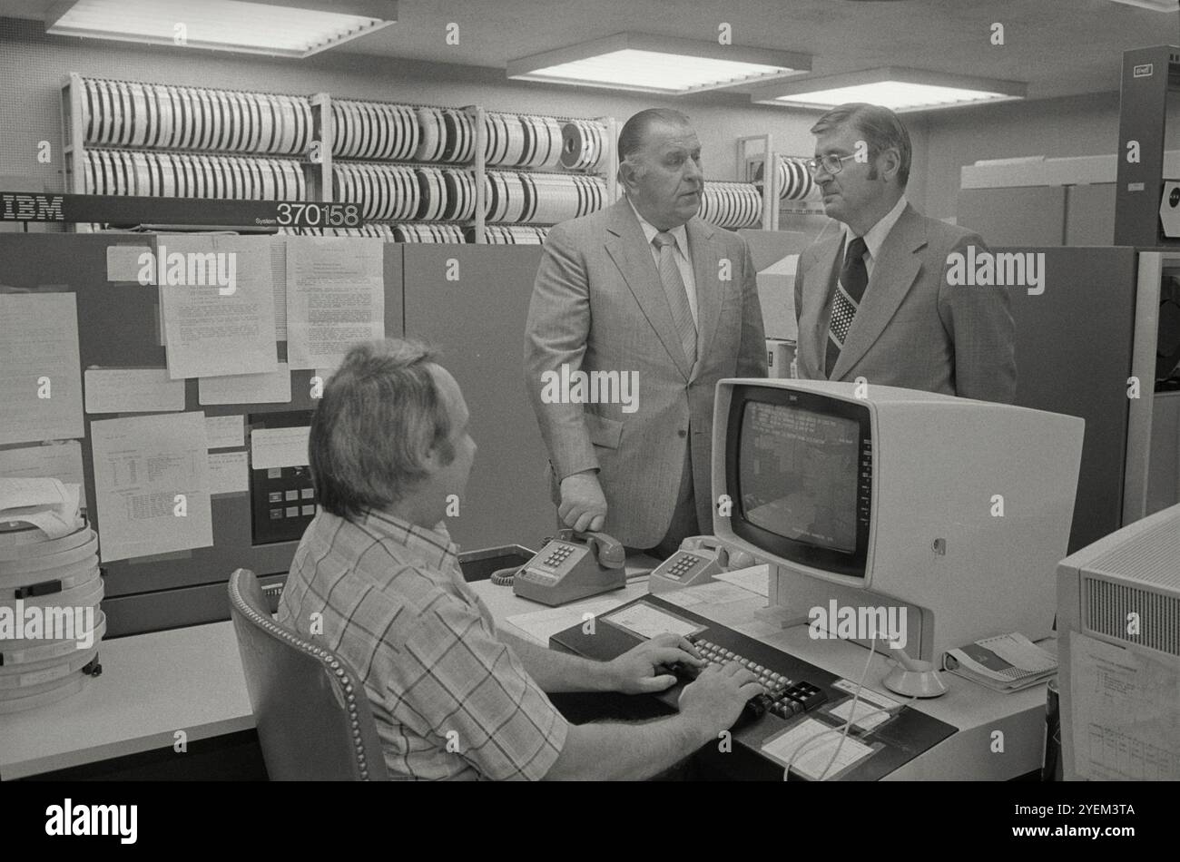 Frank Nordhoff (F. Nordy) Hoffman, Senate Sergeant at Arms (standing left) with man at computer. USA. 3 May 1977 Frank Nordhoff 'Nordy' Hoffman (1909–1996) was an American college football player at the University of Notre Dame where his record as All-American guard during the 1930 and 1931 seasons was commemorated, in 1978, with election to the College Football Hall of Fame. From 1975 to 1981, he served as the Sergeant at Arms of the United States Senate. Stock Photo