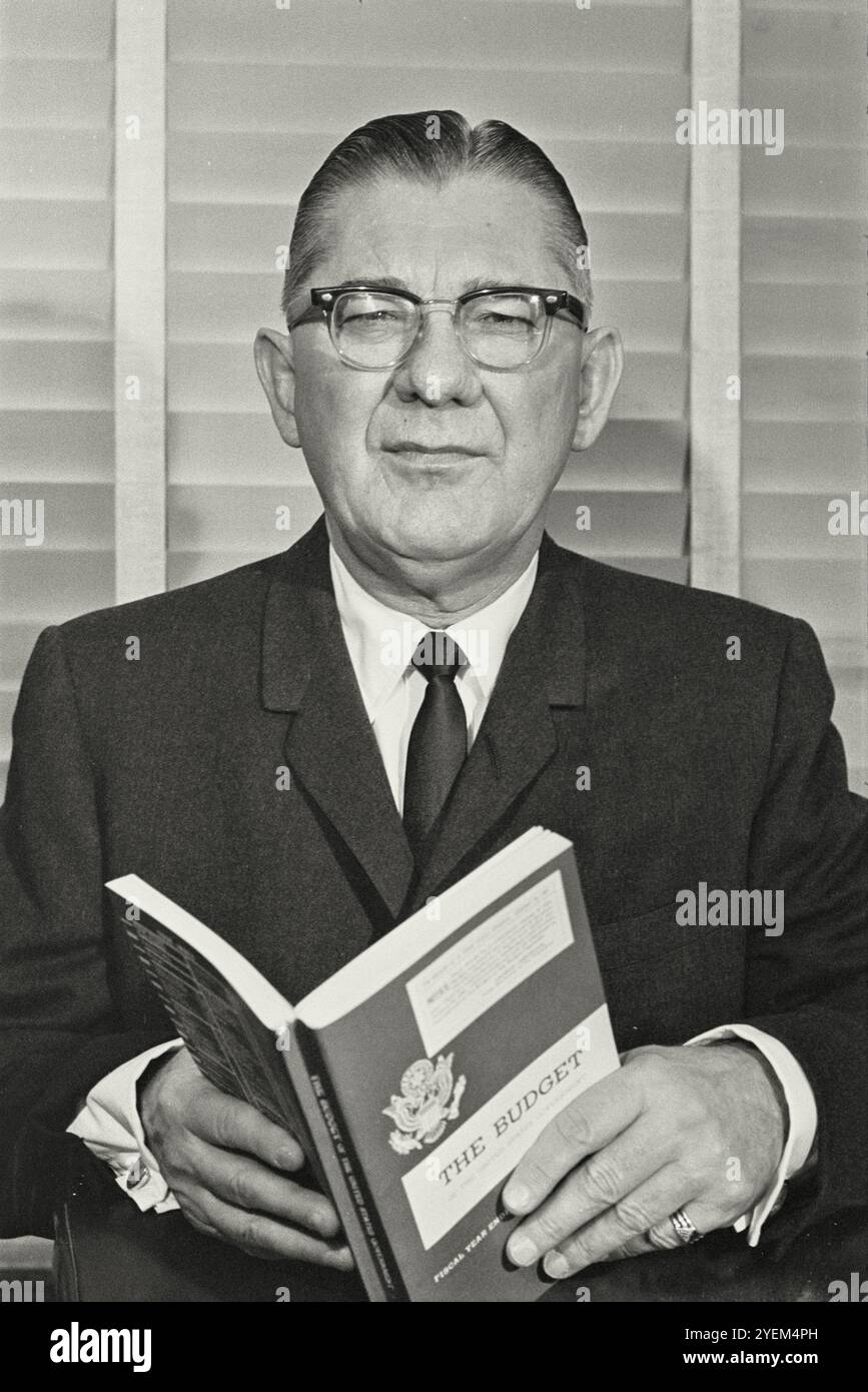 U.S. Representative Wilbur Mills, Chair of the House Ways and Means Committee, half-length portrait, standing, facing front, holding a copy of the Budget of the United States. USA. 25 May 1967 Stock Photo