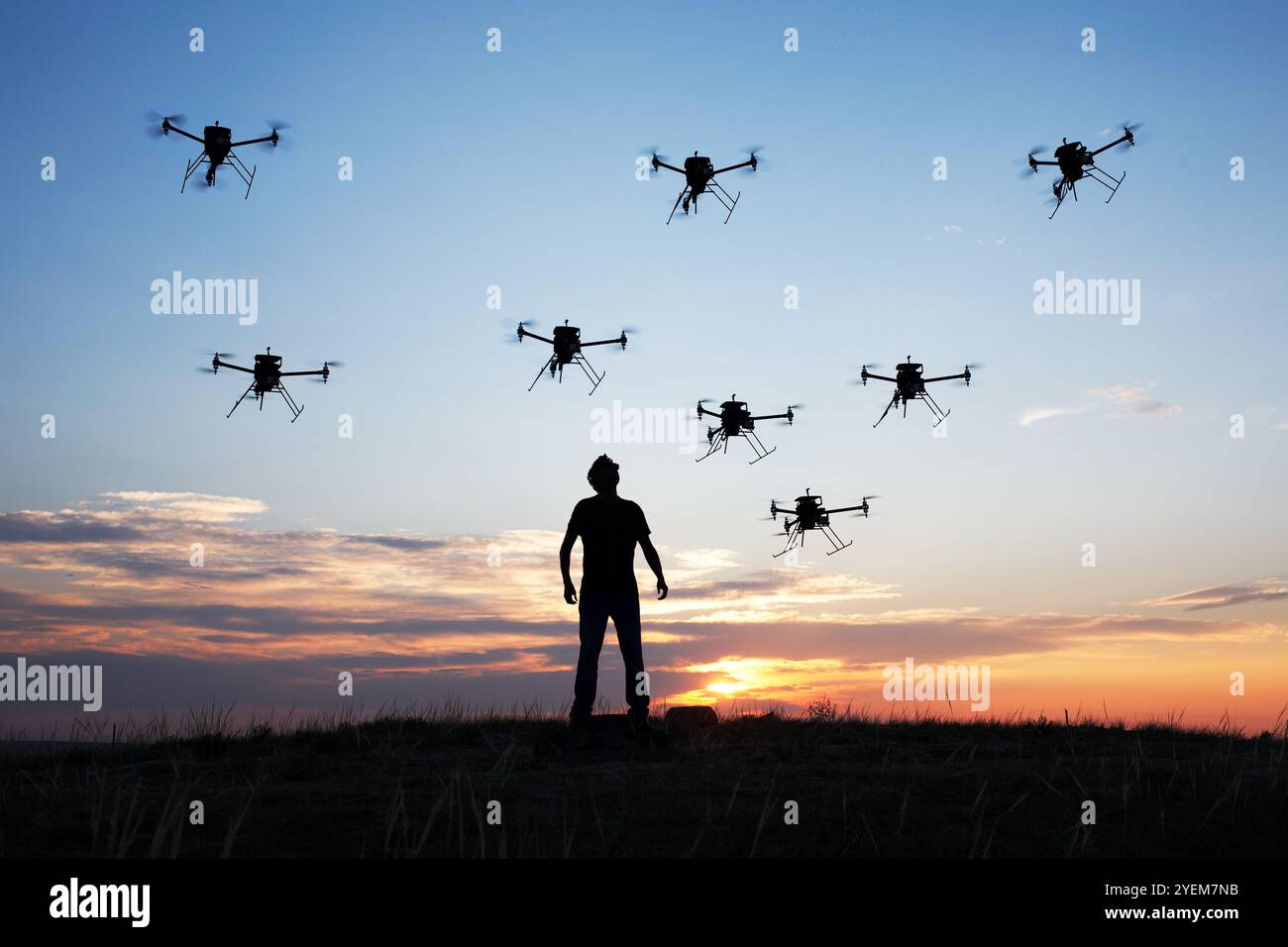 Man surrounded by a swarm of drones (UAVs) Stock Photo