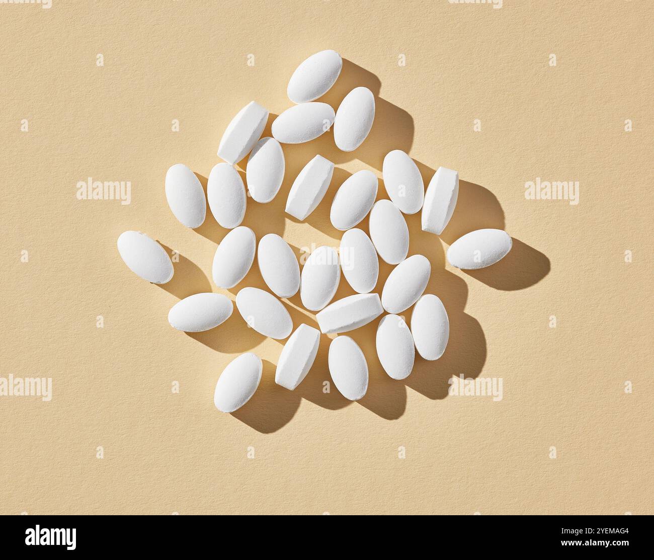 white pills on beige background, top view Stock Photo