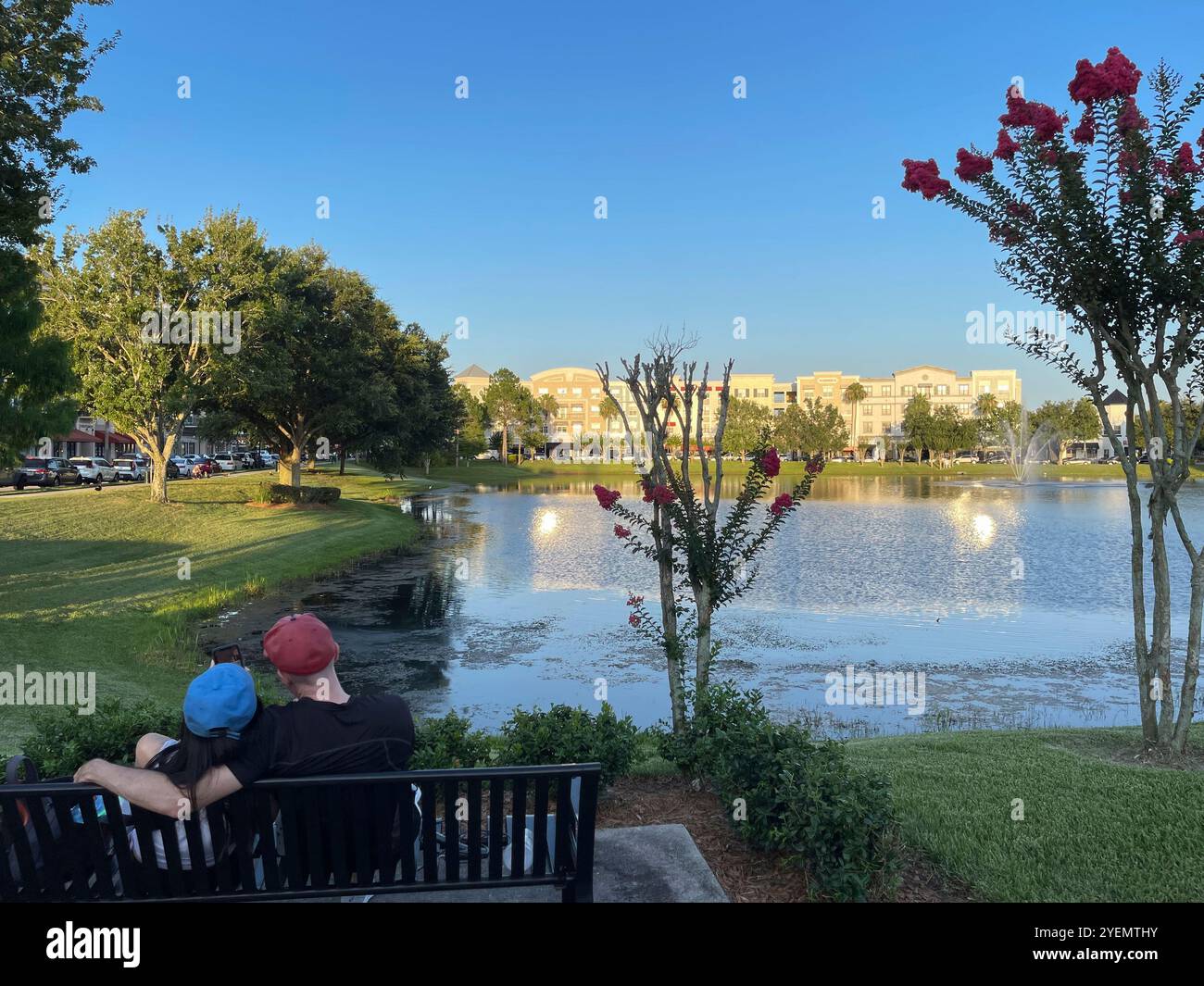 Couple sitting on a bench at Avalon Park, Orlando, Florida, USA - Smartphone Captured Stock Image