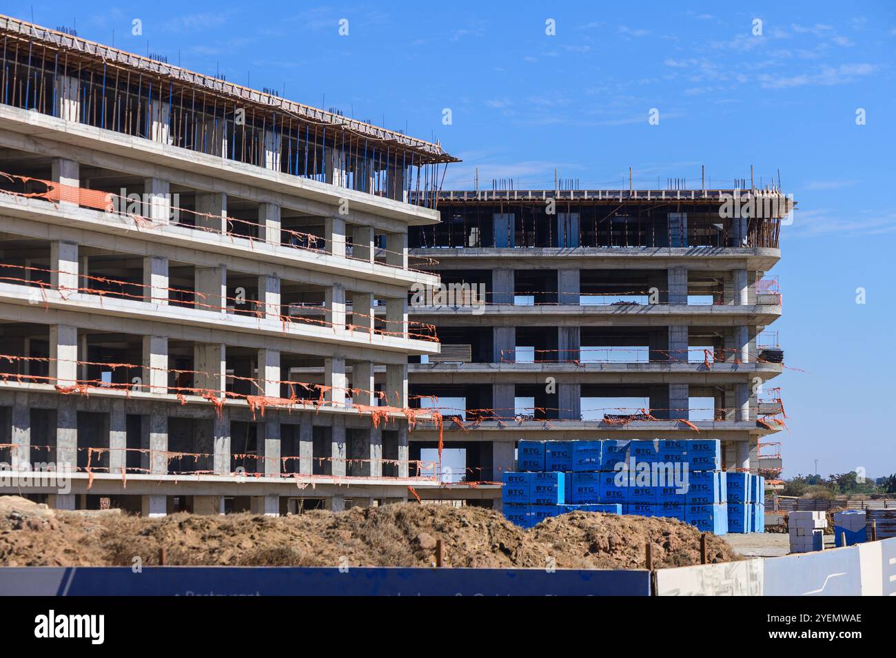 Solid Structures Examples Low Rise Construction Workers are busy on-site as concrete structures rise towards the clear ...