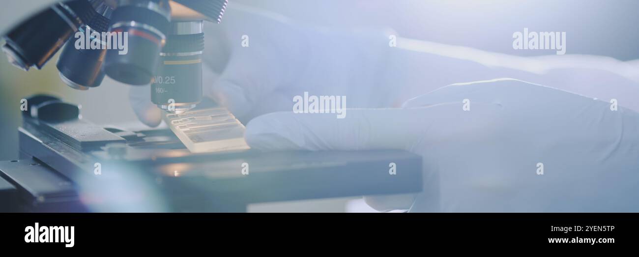 Laboratory professional using high-precision microscope for detailed ...