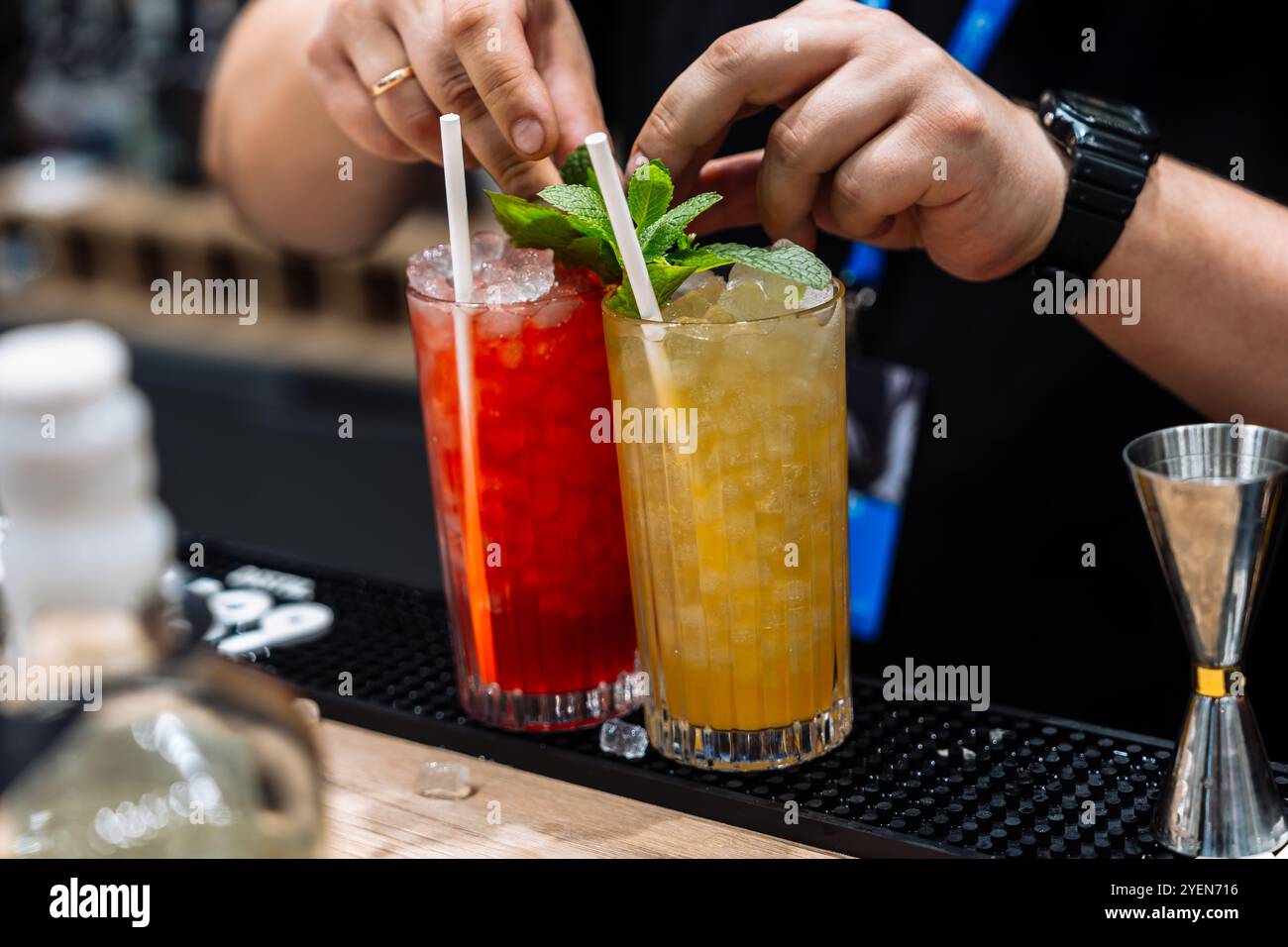 Cocktail preparation featuring vibrant drinks at a lively event Stock Photo