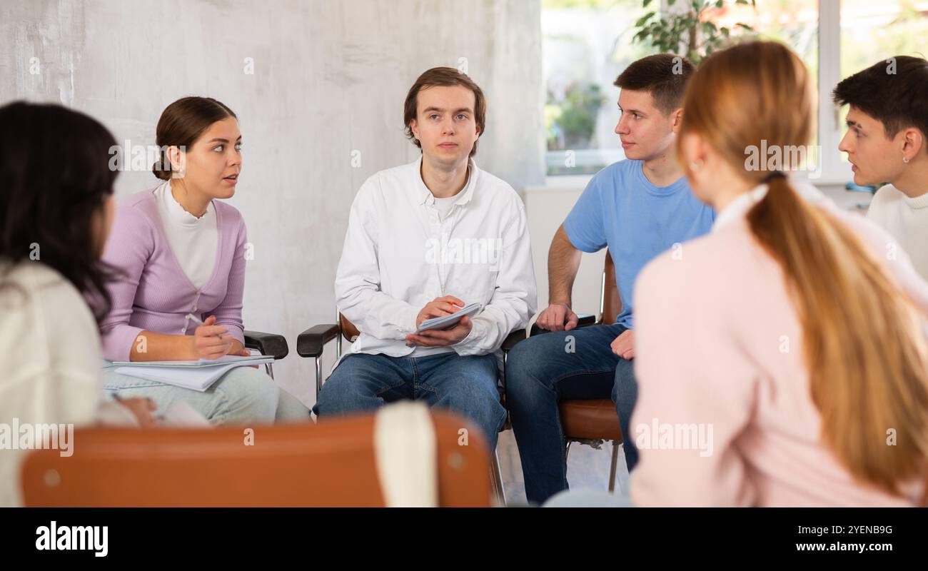 Group of students studying for difficult test in studygroup together Stock Photo