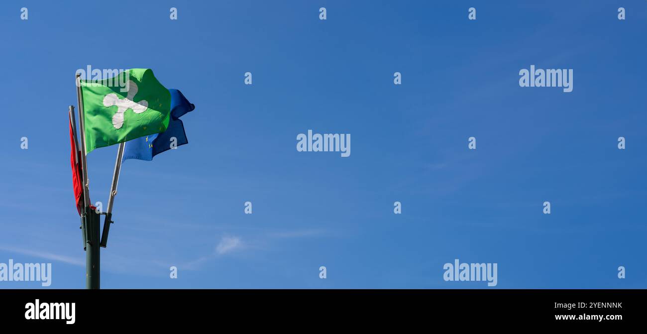 Flags waving against a clear blue sky on a windy day Stock Photo - Alamy