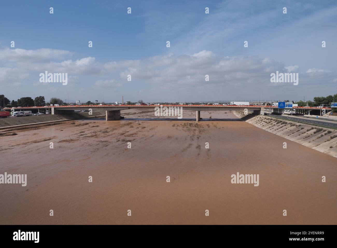 VALENCIA, SPAIN OCTOBER 31, 2024 Muddy river water flowing under a