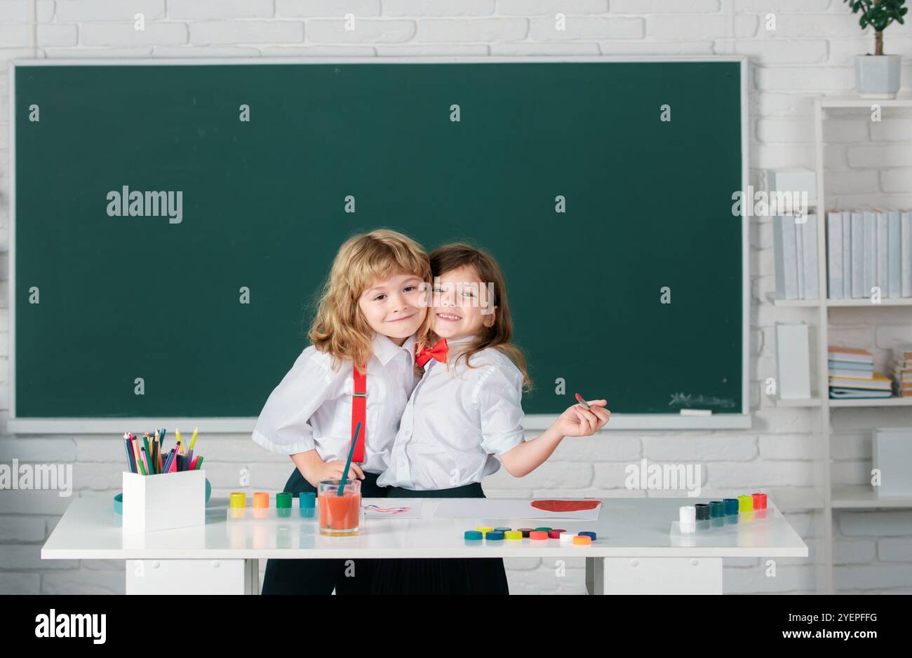Kids creative growth. School children girl and boy hugging embrave and ...