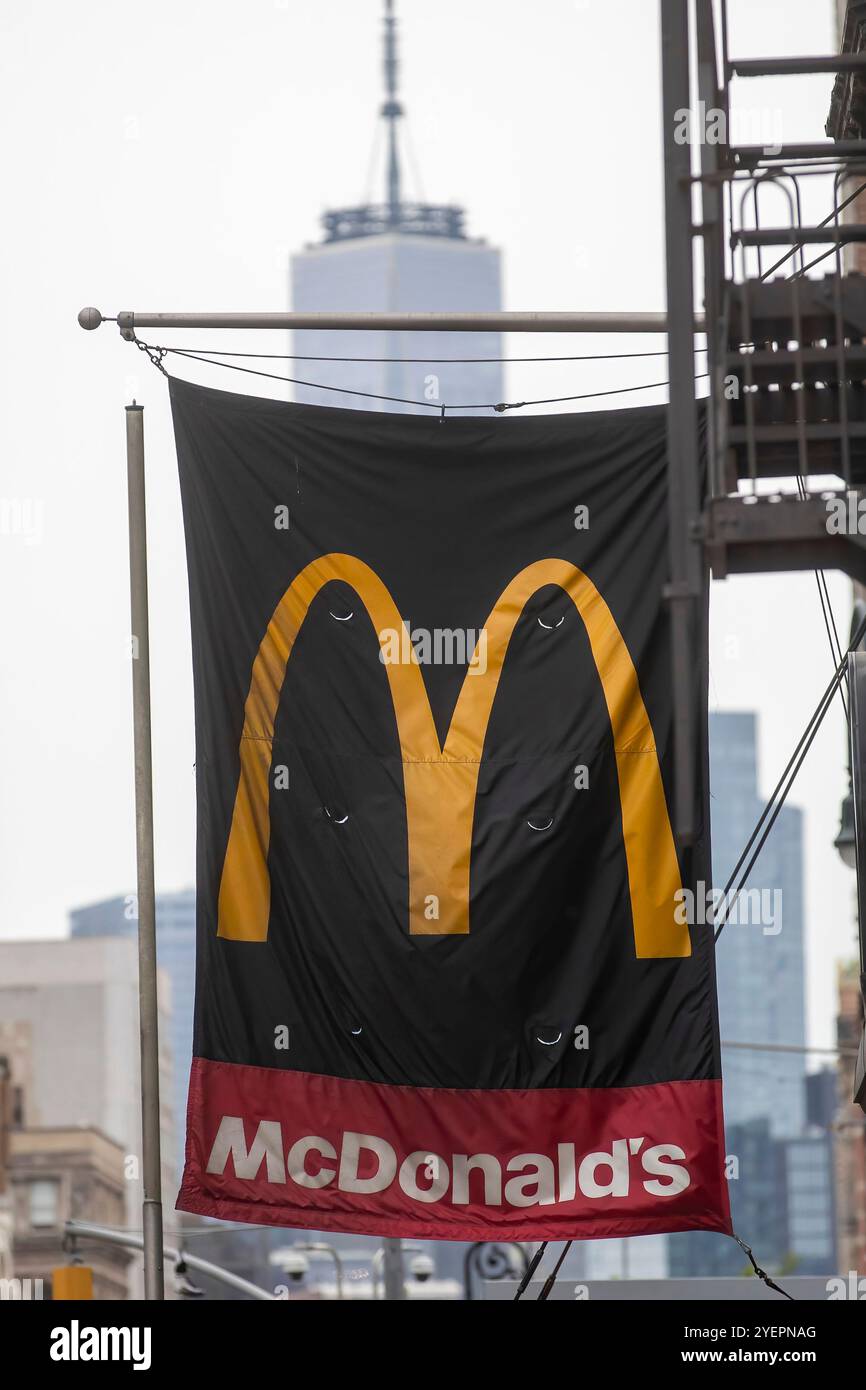 A McDonald's sign featuring the golden arches logo and an arrow