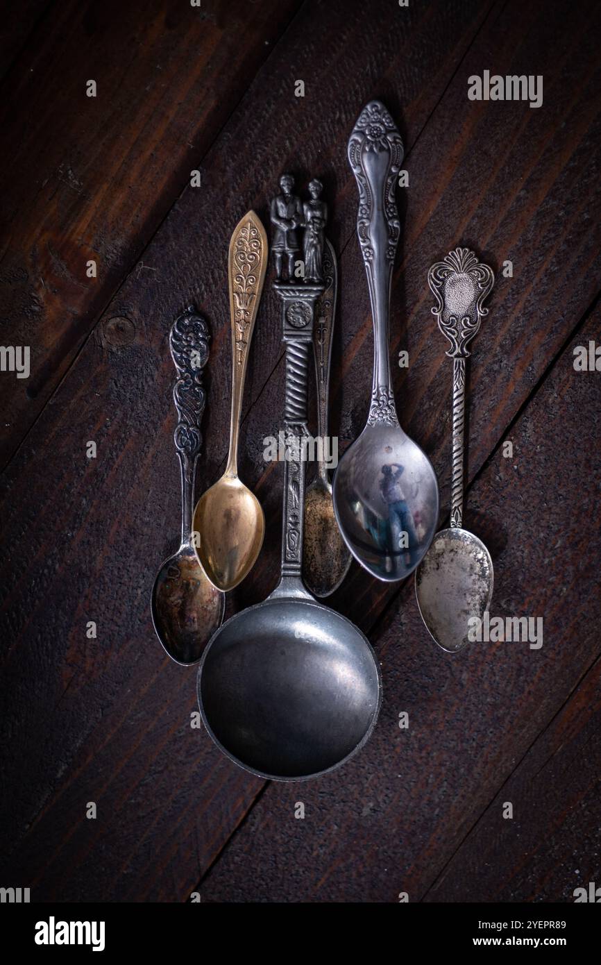 Silver spoons over a wood table Stock Photo