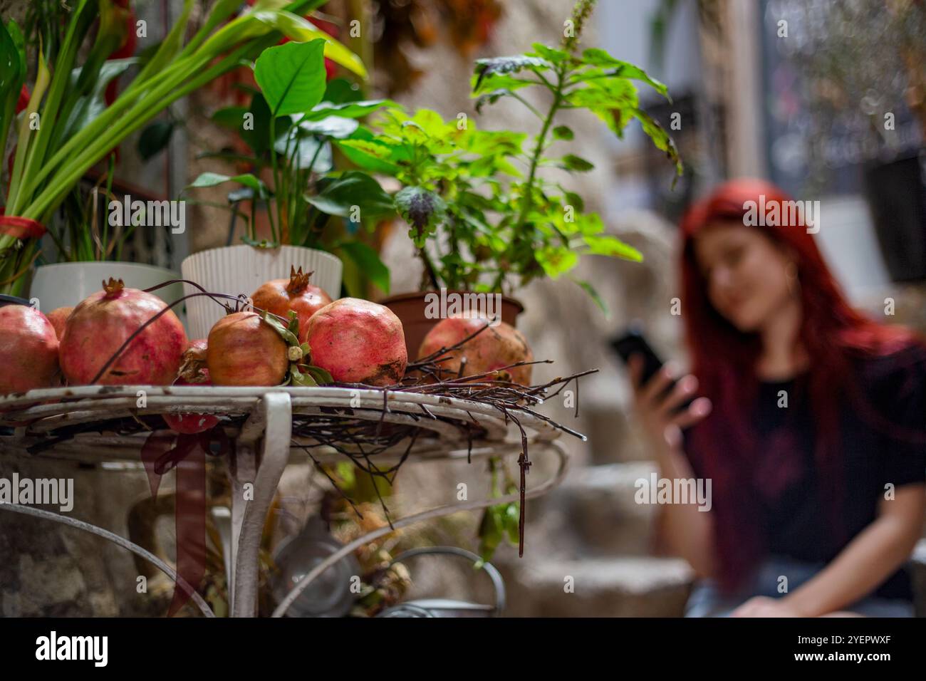 Woman sitting against stone hi-res stock photography and images - Alamy