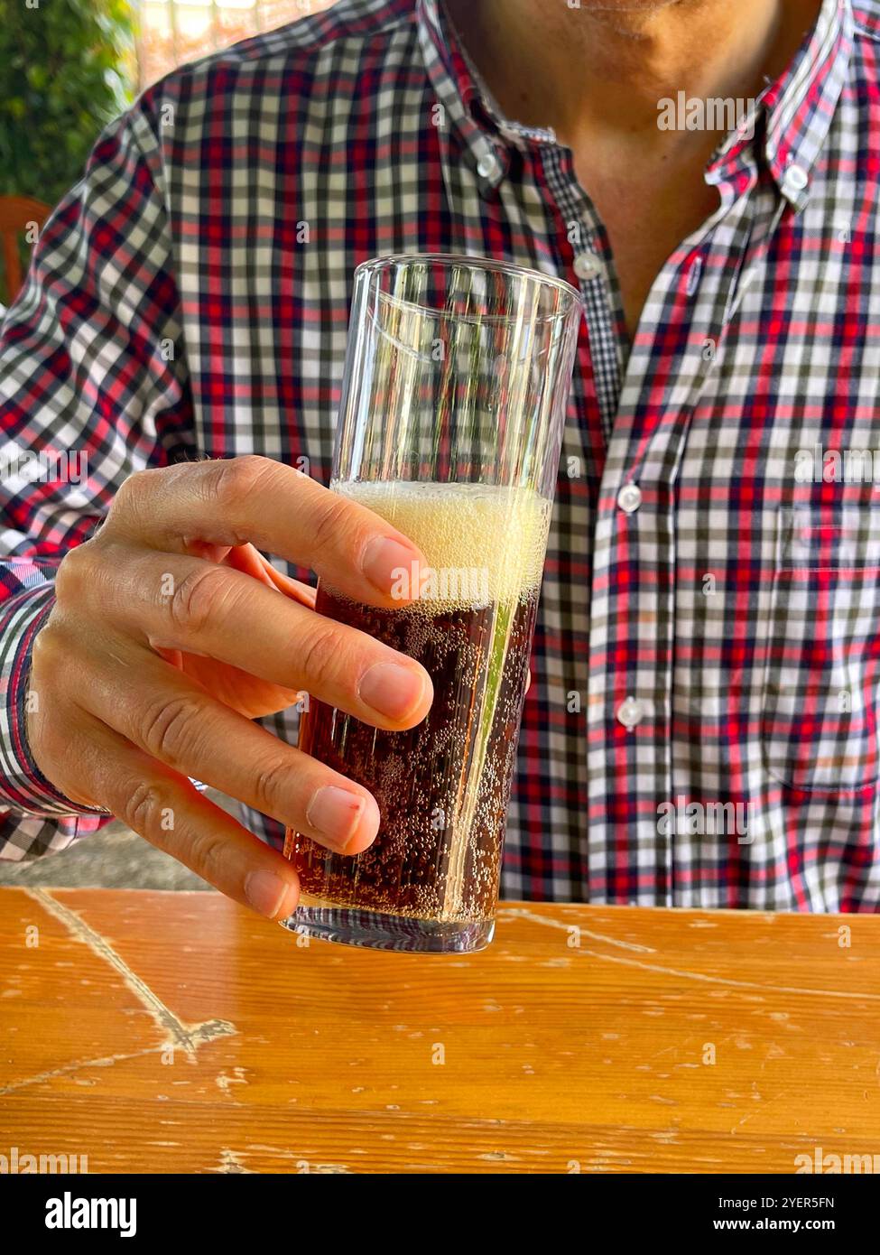 Man drinking a glass of beer. - Smartphone Captured Stock Image