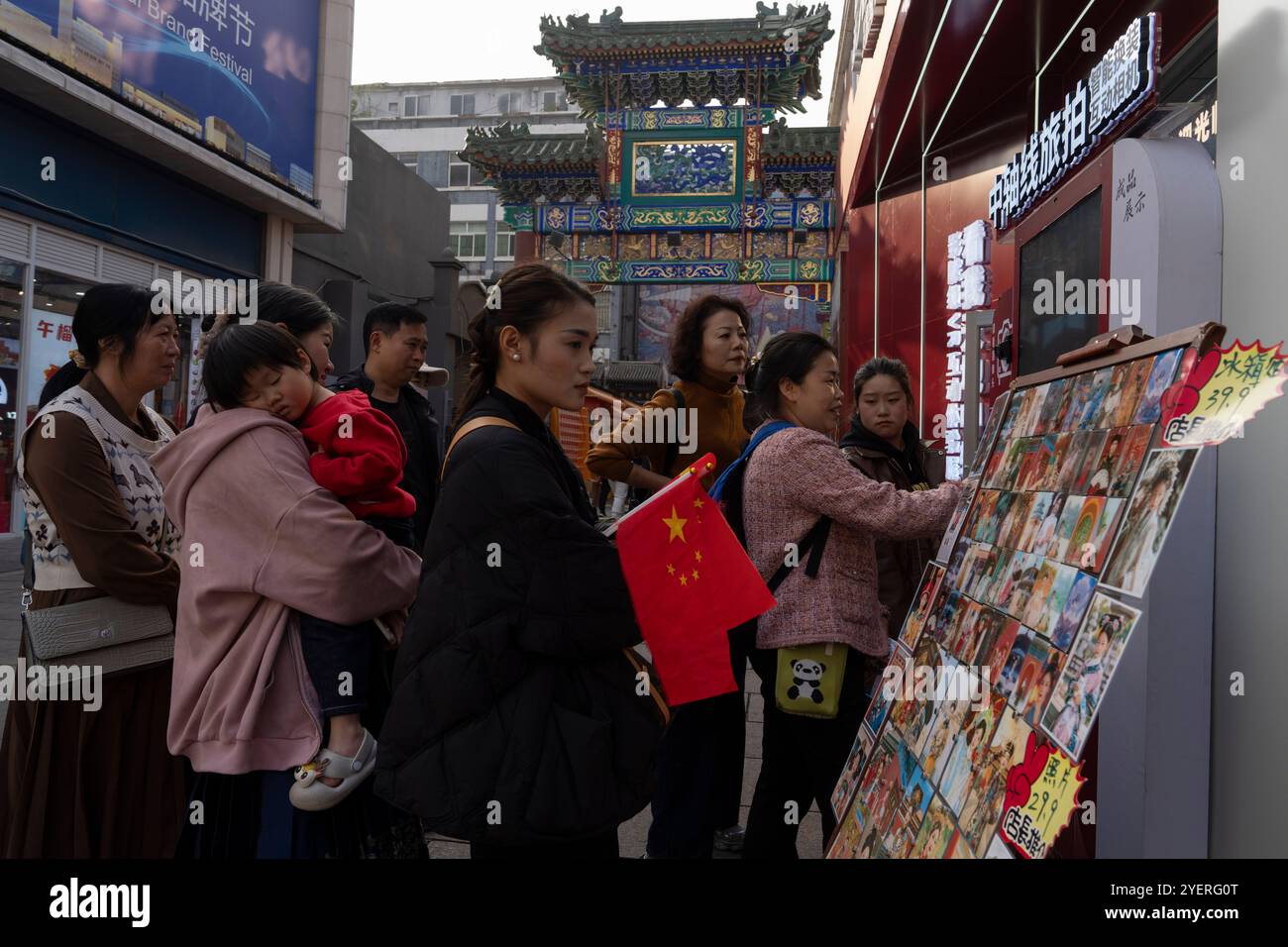 Tourists line up at a photo booth that uses artificial intelligences to ...