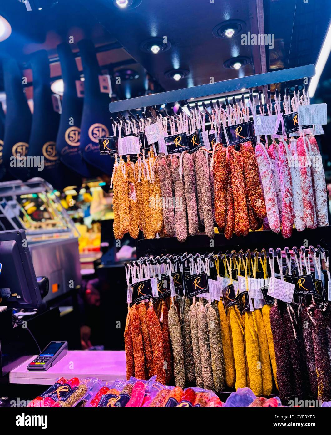 Cured meats displayed at a shop at the Mercat de la Boqueria in Barcelona, Spain. - Smartphone Captured Stock Image