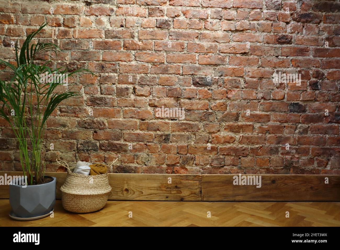 Minimalist Brick Wall Interior with Potted Plant and Wicker Basket ...