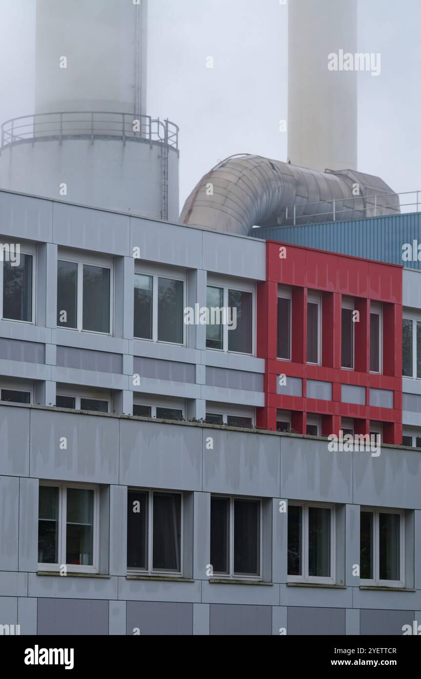 Steam rising from chimneys behind an industrial building with a ...