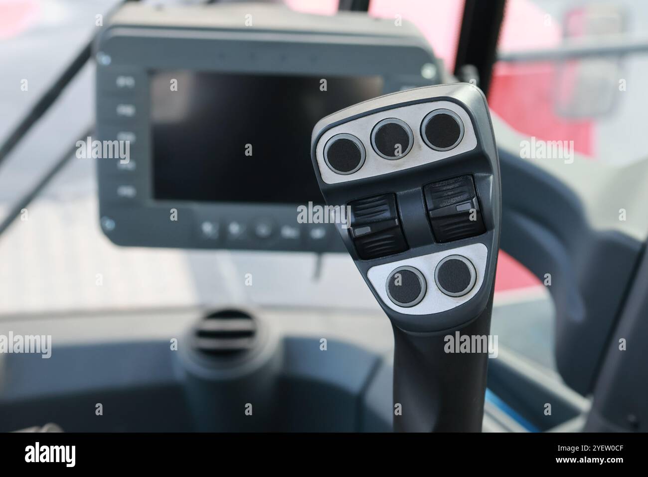 Detailed view of a reach stacker control joystick in the cabin, highlighting modern cargo handling. Stock Photo