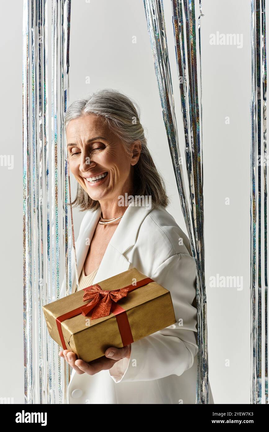 Mature woman wrapping christmas gift hi-res stock photography and ...