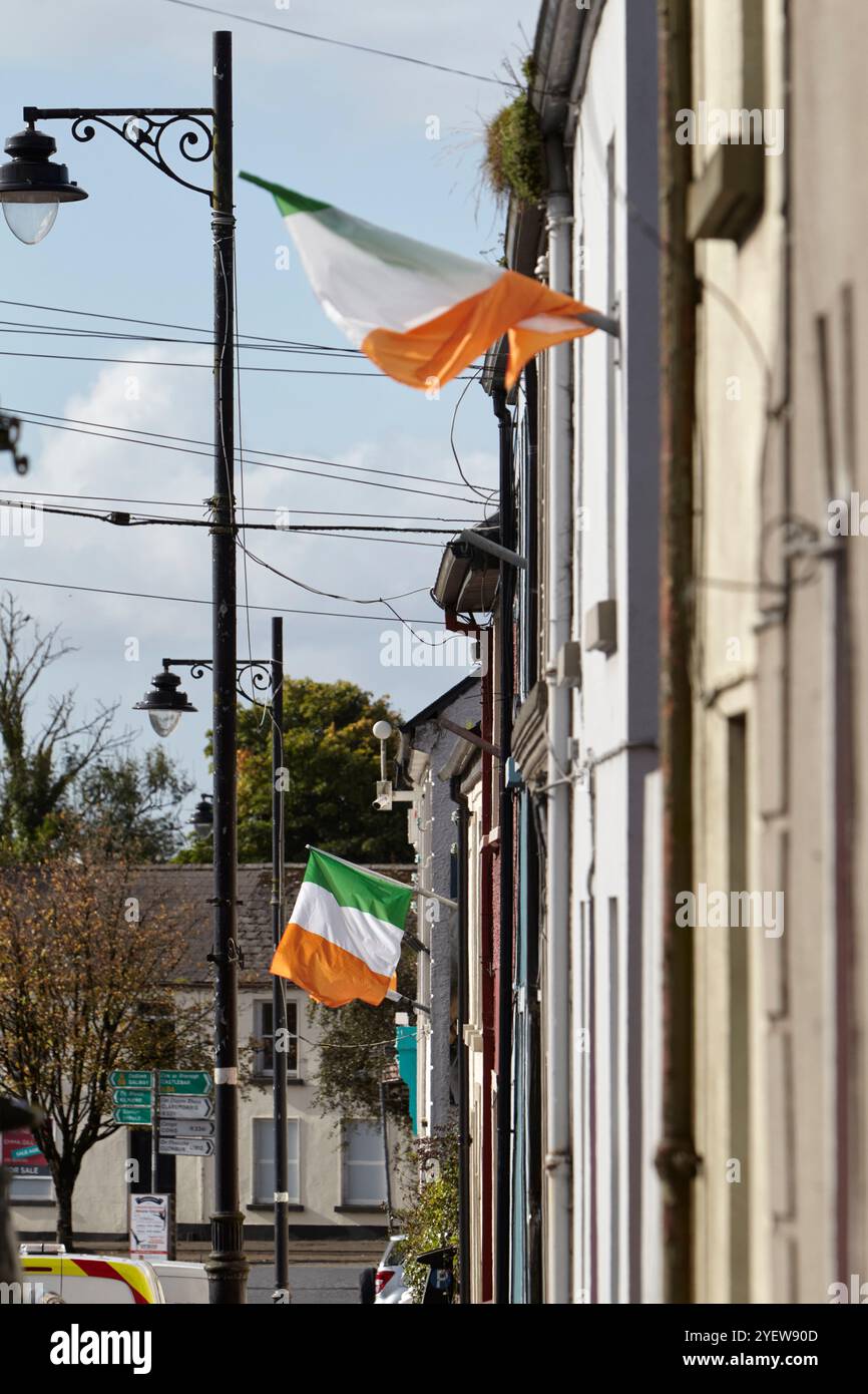 irish tricolours national flag of ireland flying from terraced houses in Ballinrobe, county mayo, republic of ireland Stock Photo