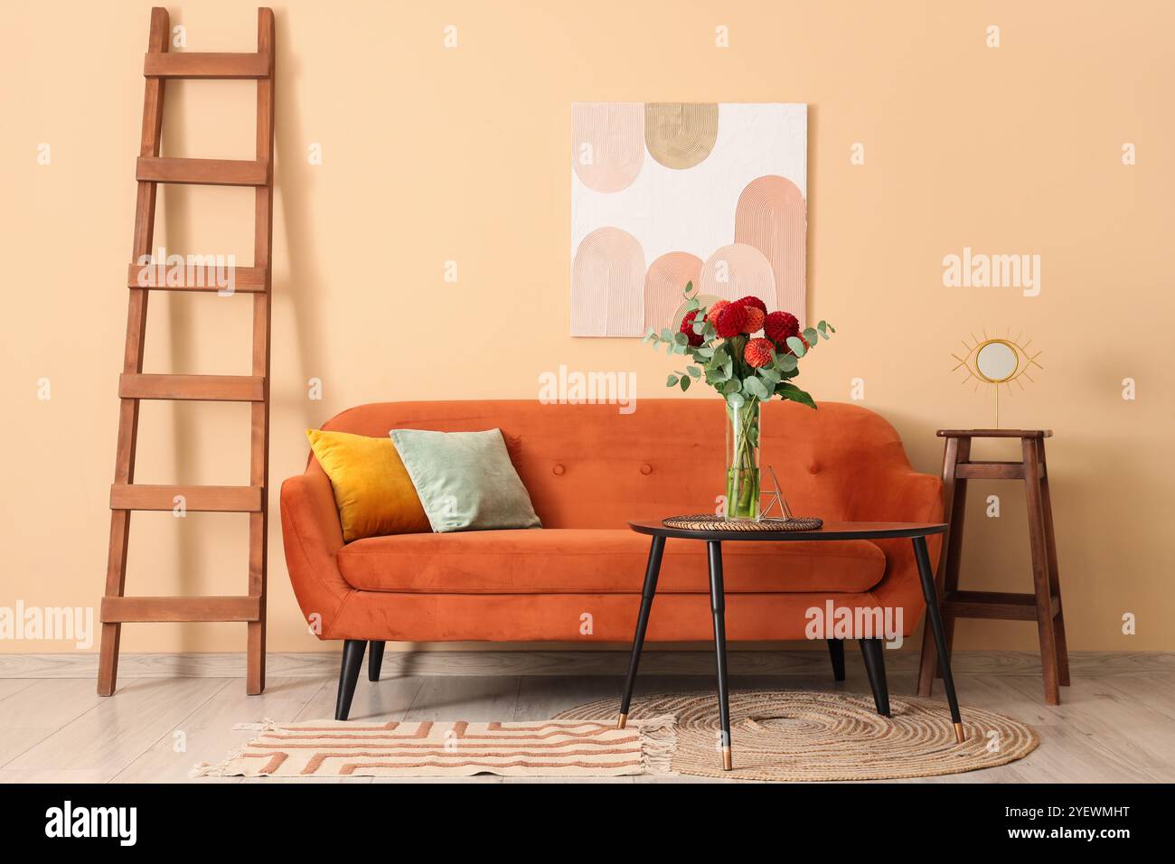 Cozy sofa and dahlia flowers in vase on coffee table in room Stock ...