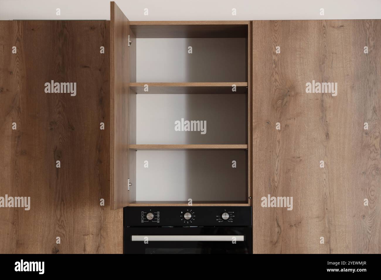 Open cupboard with shelves in modern kitchen interior Stock Photo