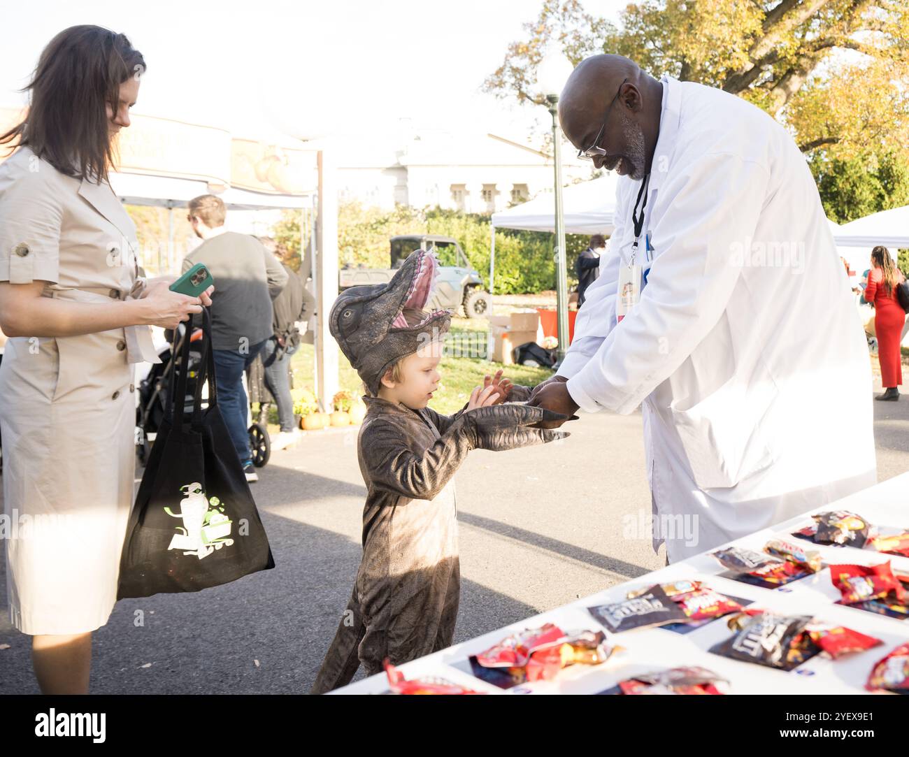 Washington, United States. 30th Oct, 2024. NASA space agency employees hands out photos and candy to young visitors at the “Hallo-READ” event during Halloween celebrations at the South Lawn of the White House, October 30, 2024, in Washington, DC Credit: Aubrey Gemignani/NASA Photo/Alamy Live News Stock Photo