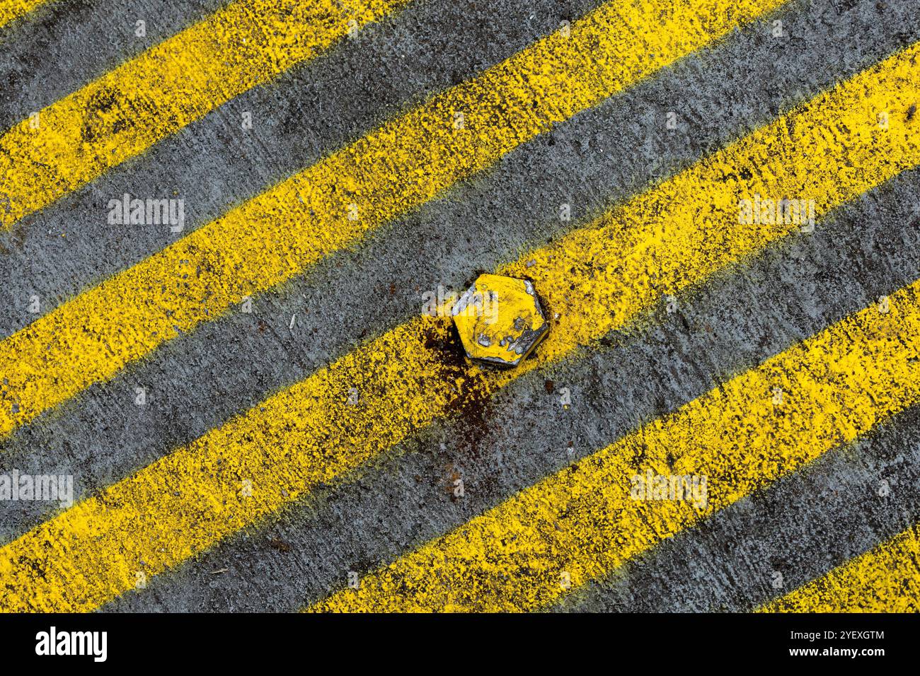 Bold yellow lines on roadway form a pleasing abstract image. Stock Photo