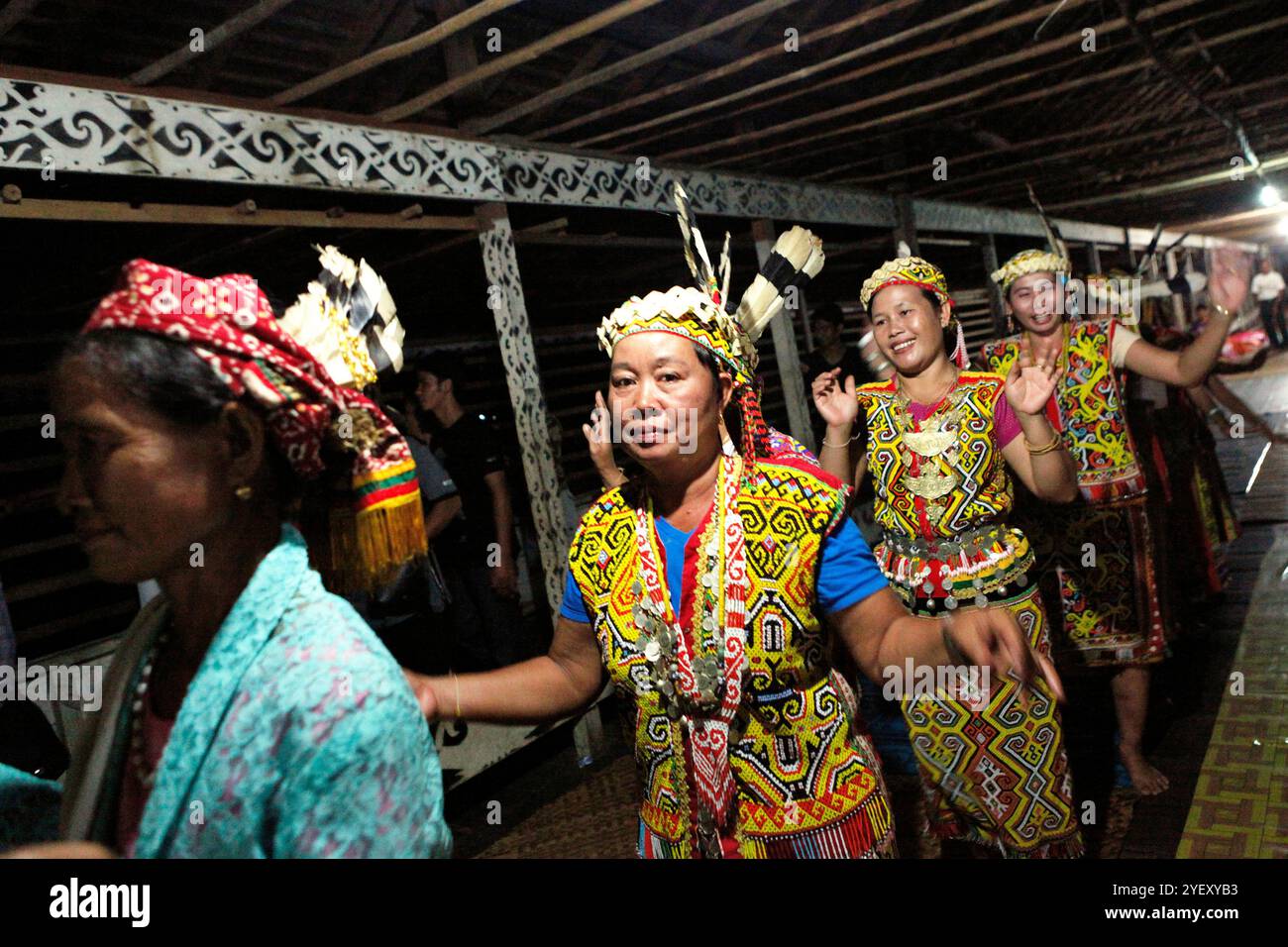 Women dance in a line, as they are welcoming guests during an ...
