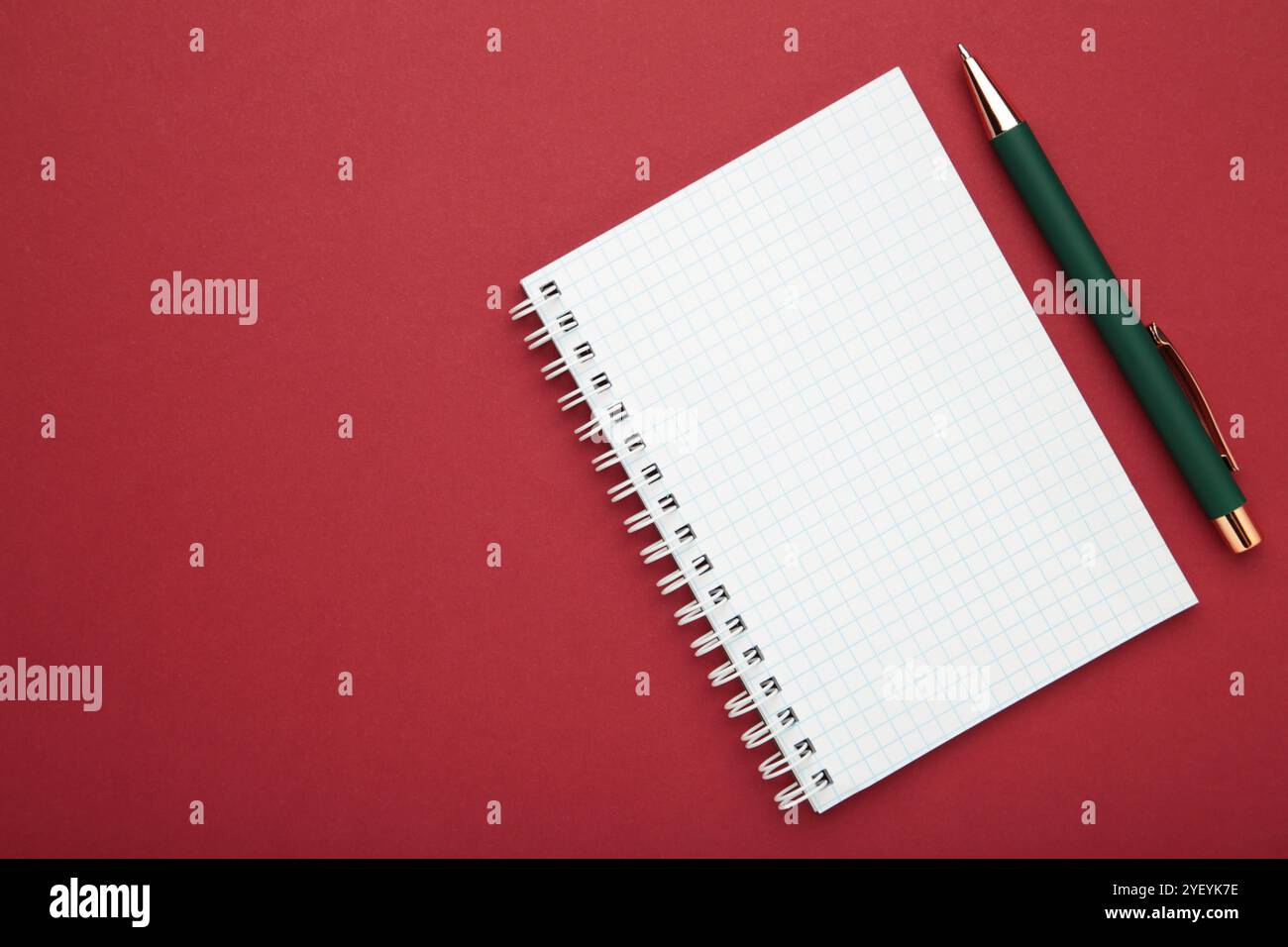 Notebooks and pen on red background, top view Stock Photo