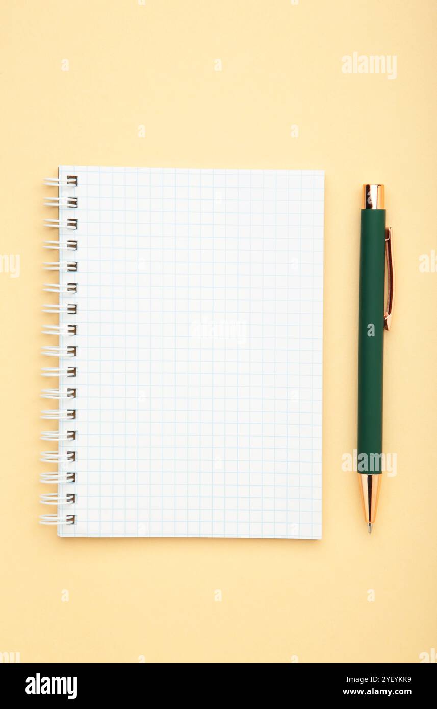 Notebooks and pen on beige background, top view Stock Photo