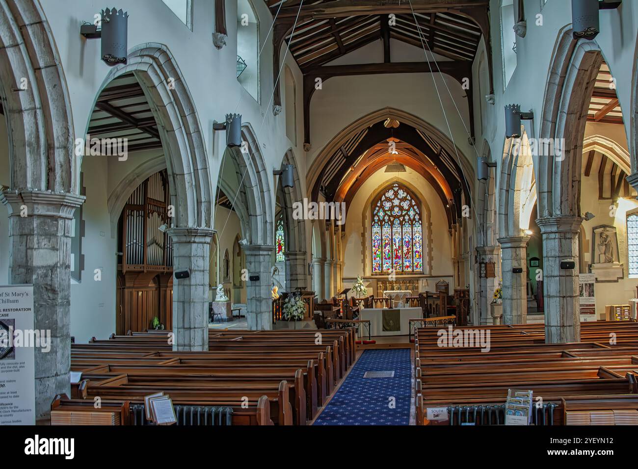 The interior of the 13th century St Mary's Church, known for its stained glass windows and memorials to notable figures. Chilham, Kent, UK Stock Photo