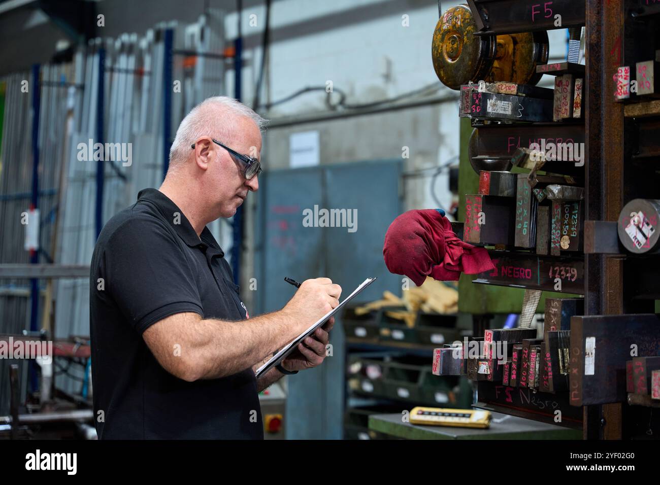 Metalworker operating cnc machine hi-res stock photography and images ...