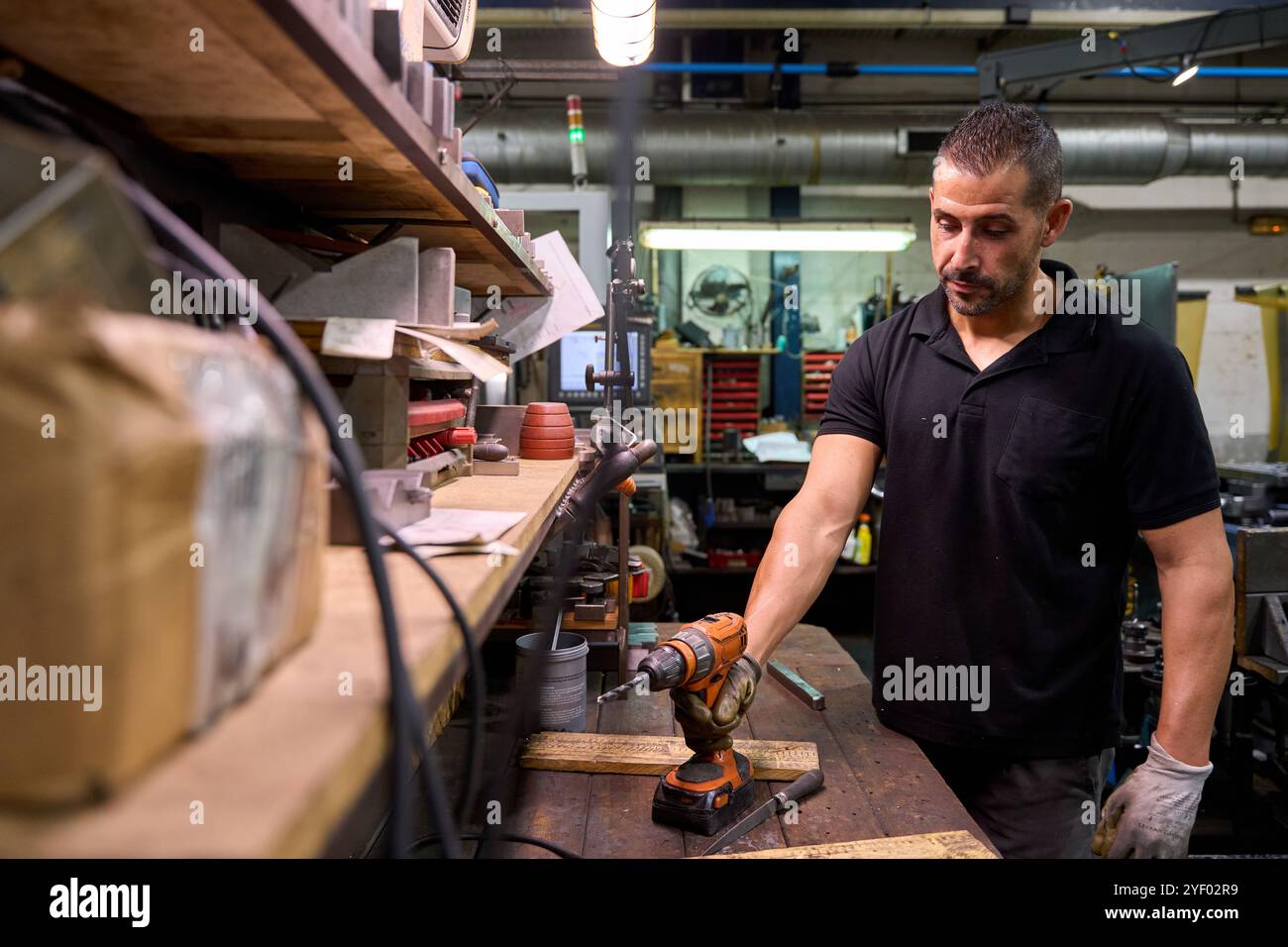 Metalworker operating cnc milling machine in factory Stock Photo