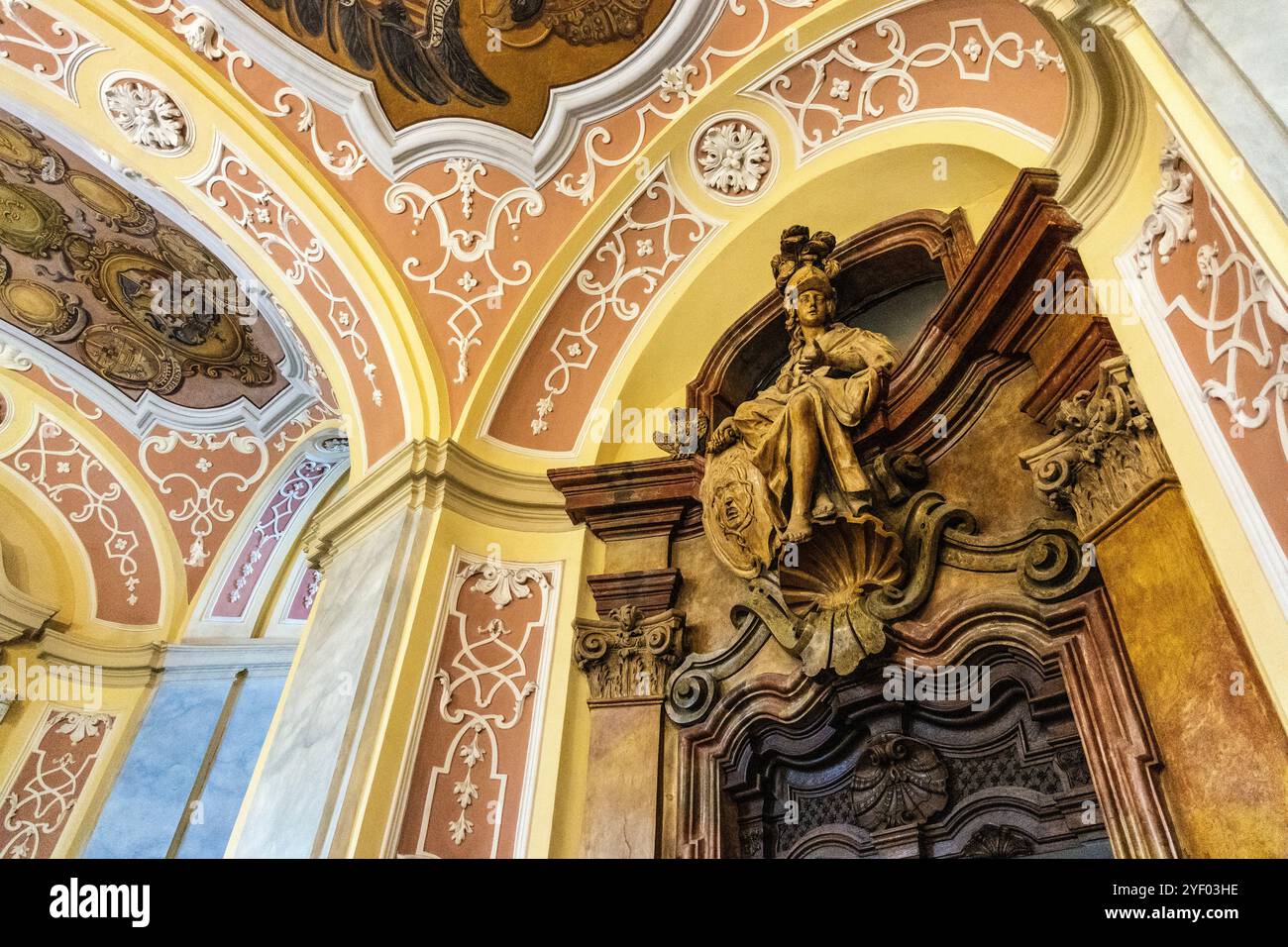 Ornate baroque entrance hall with statue over a doorway, University of Wroclaw, Poland Stock Photo