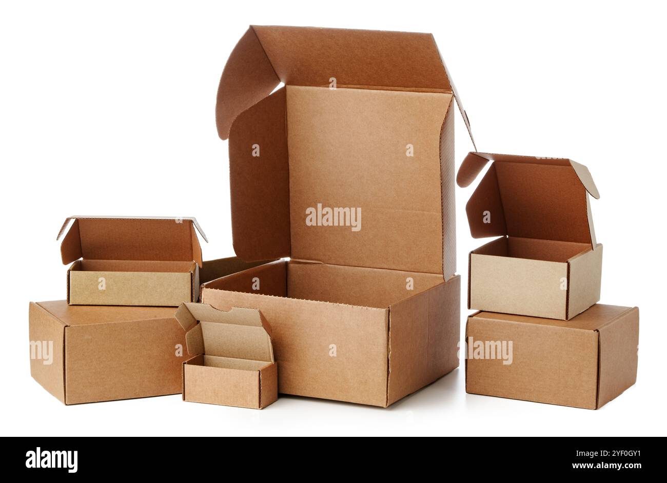 Stacked brown cardboard boxes in various sizes arranged on a white background Stock Photo