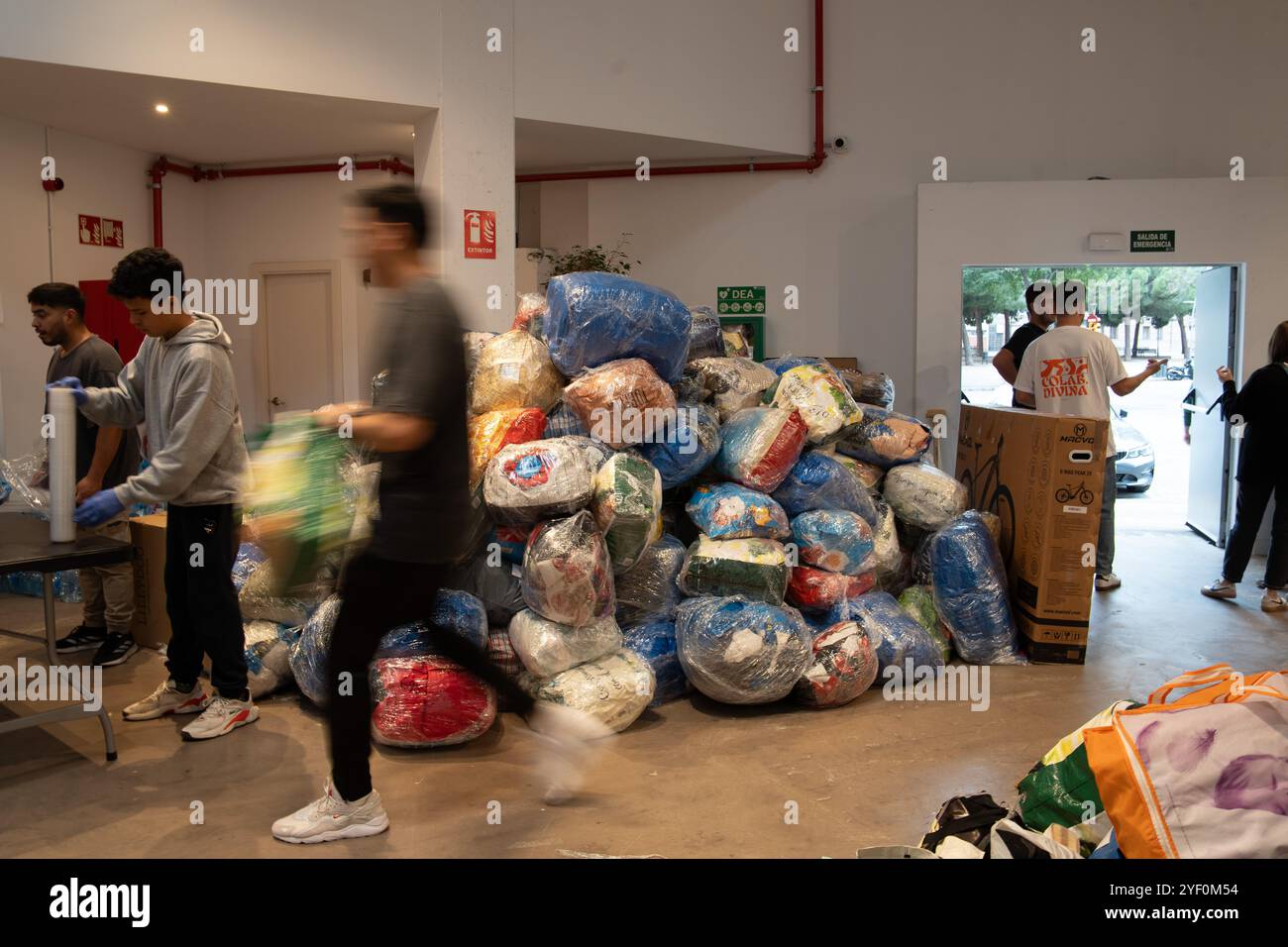 Barcelona rallies in a show of solidarity with its Valencian neighbors, bringing food, blankets, and essential supplies, as well as brooms and shovels for the cleanup efforts in the affected areas of Valencia. Among the most notable contributions are those from the Hillsong Evangelical Church. Additionally, the &quot;castellers&quot; of Barcelona, a group that forms human towers, has organized a food drive under the slogan, &quot;Only the people save the people,&quot; referring to criticism of the government's inaction. Barcelona se vuelca en una muestra de solidaridad con sus vecinos Stock Photo