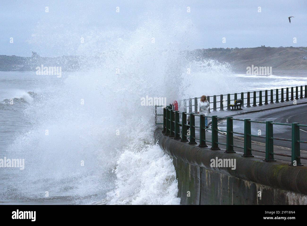 Sandsend, North Yorkshire, UK. 2nd November, 2024.  Waves from the high tide crash against the harbour wall at Sandsend, North Yorkshire Neil Squires/Alamy Live News Stock Photo