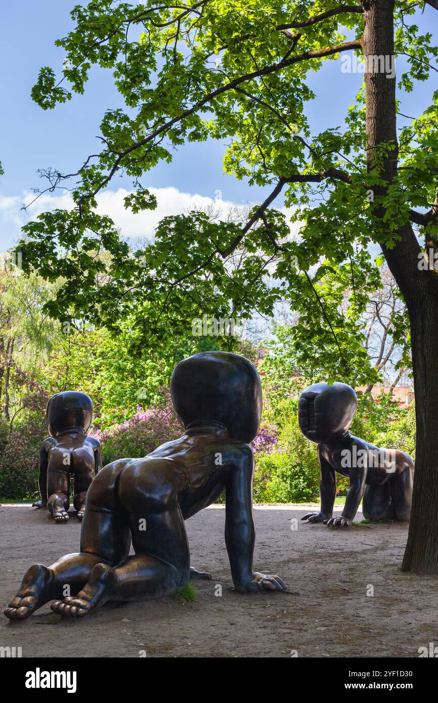 Miminka, or Babies, the iconic bronze sculptures by Czech artist David Černý located in Kampa Park, near the Kampa Museum in Prague, Czech Republic. Stock Photo