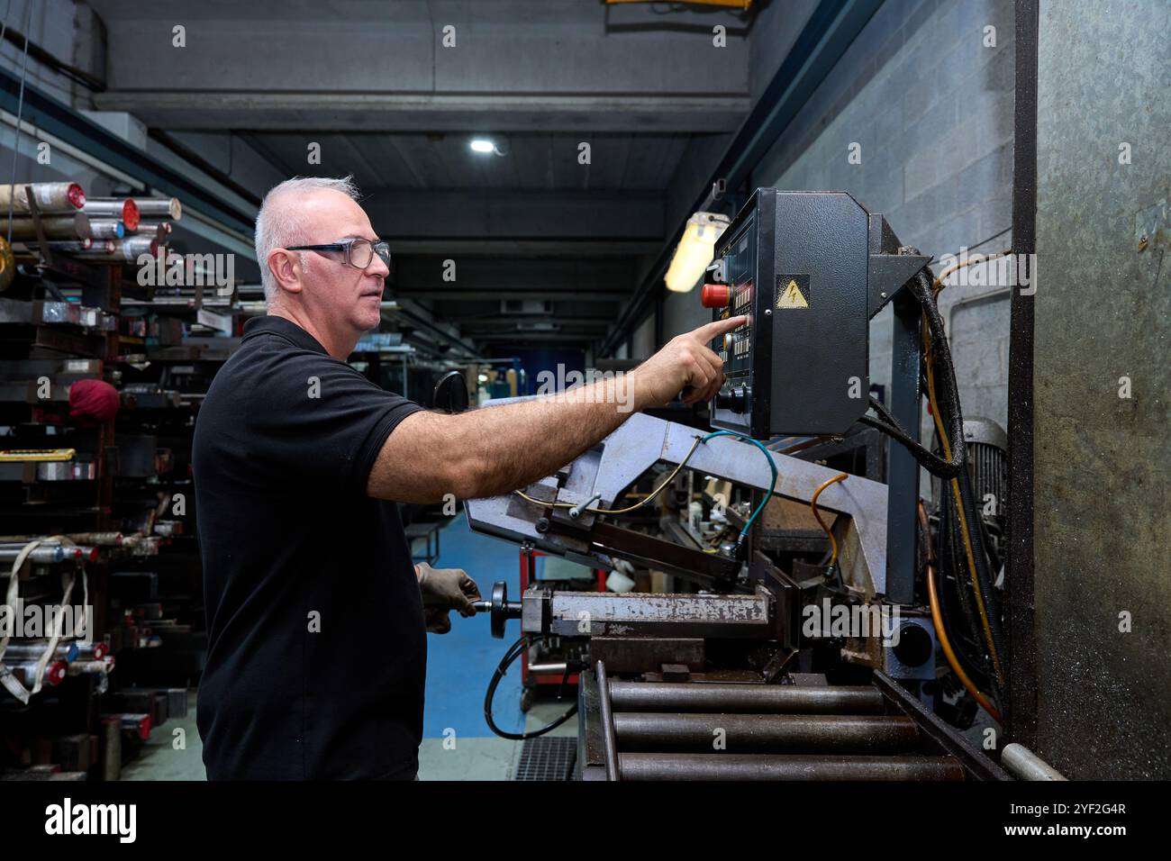 Metalworker examining fabric in metallurgy workshop Stock Photo - Alamy