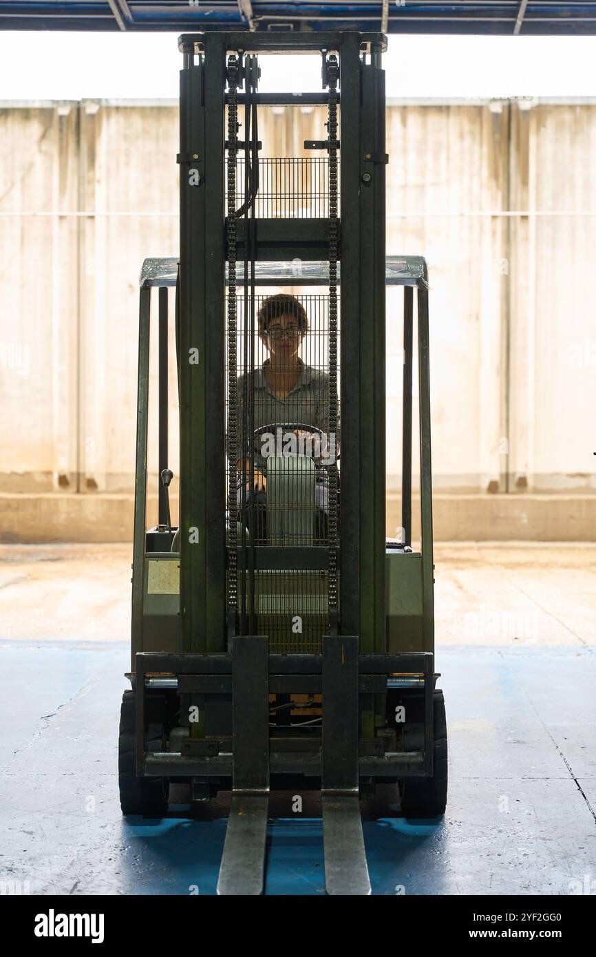 Metallurgy workers programming industrial machinery using computer in ...