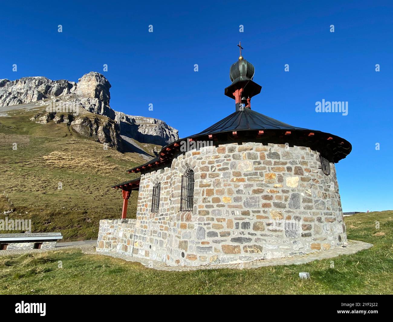 Charming Stone Chapel Against a Mountainous Backdrop - Smartphone Captured Stock Image