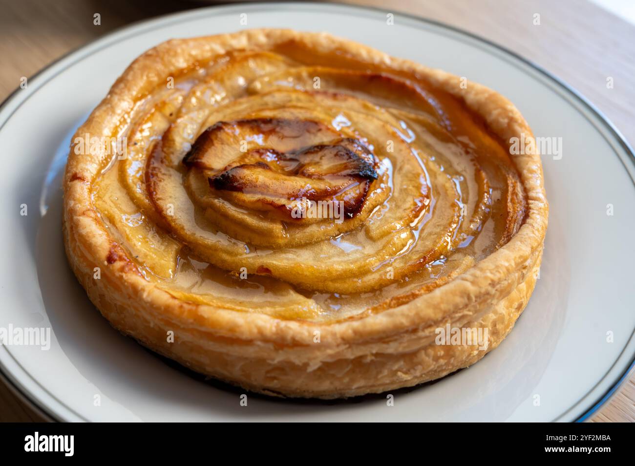 French fresh baked sweet puff pastry with fresh apple fruits in sirup ...
